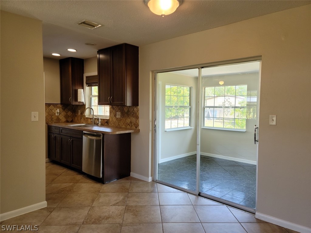 1509 Lindale Circle Lehigh Acres, FL 33936 - Photo 4 of 16 a kitchen with a sink a counter top space and appliances