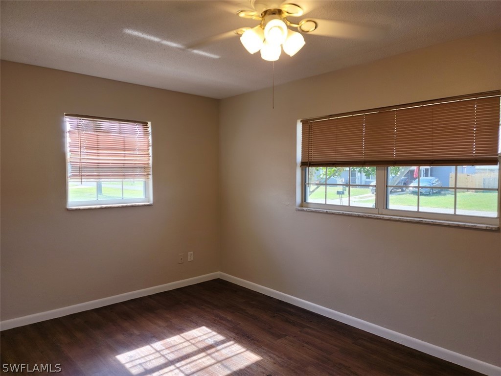 1509 Lindale Circle Lehigh Acres, FL 33936 - Photo 10 of 16 a view of an empty room with wooden floor and a window