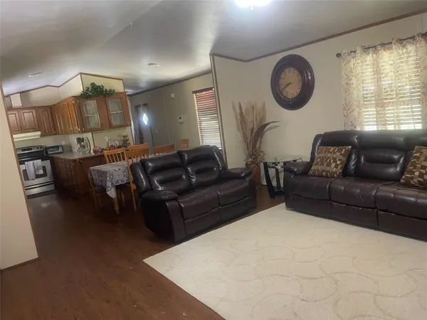 a kitchen with a table chairs sink and cabinets