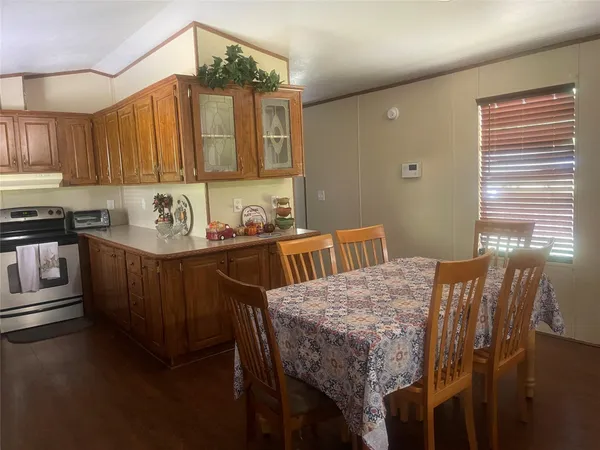 a kitchen with kitchen island sink stove and refrigerator
