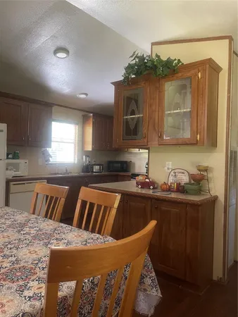 a kitchen with a stove a sink and a cabinets