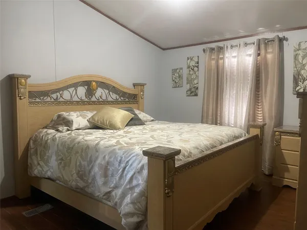 a bedroom with a bed and a dresser