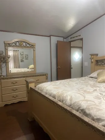 a bedroom with a bed and a dresser