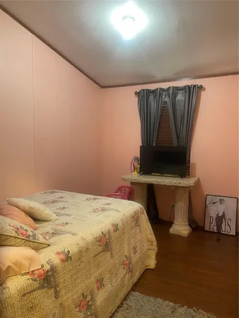 a bedroom with two beds and a night stand