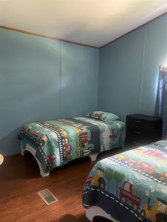 a bedroom with a bed and a chair