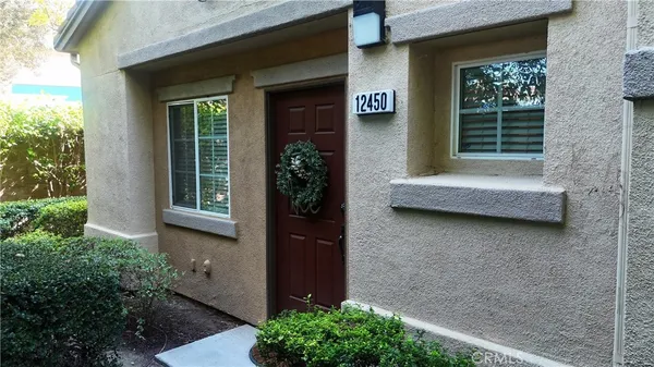 a couple of potted plants in front of door