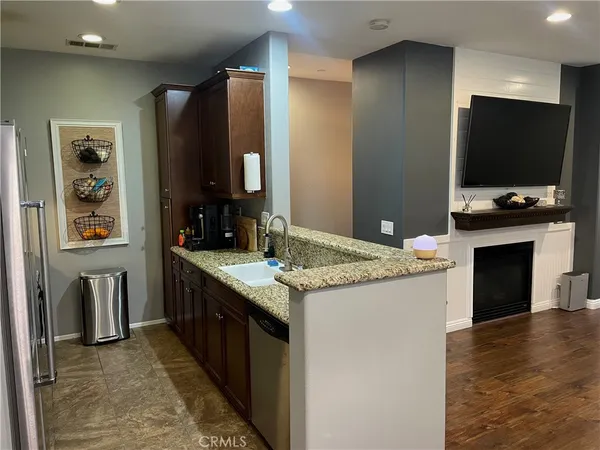 a kitchen with stainless steel appliances granite countertop a stove and a refrigerator