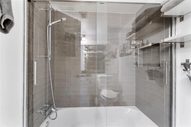 a bathroom with a shower and a sink
