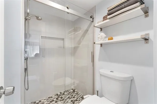 a bathroom with a shower and a toilet