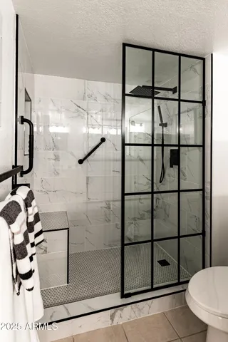 a bathroom with a glass shower door