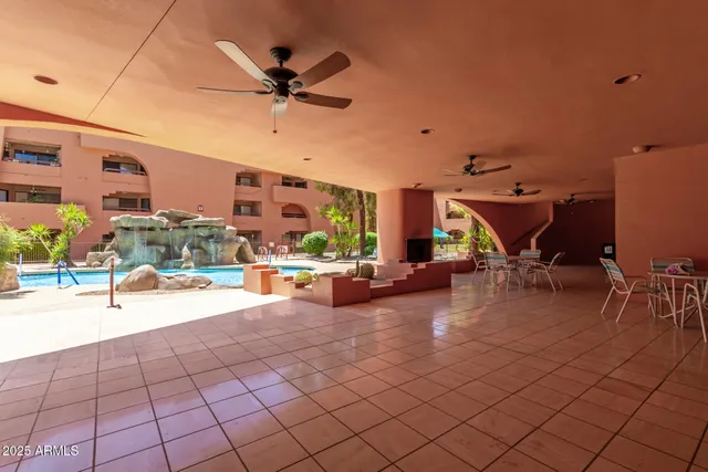 a view of a livingroom with couch and a potted plant
