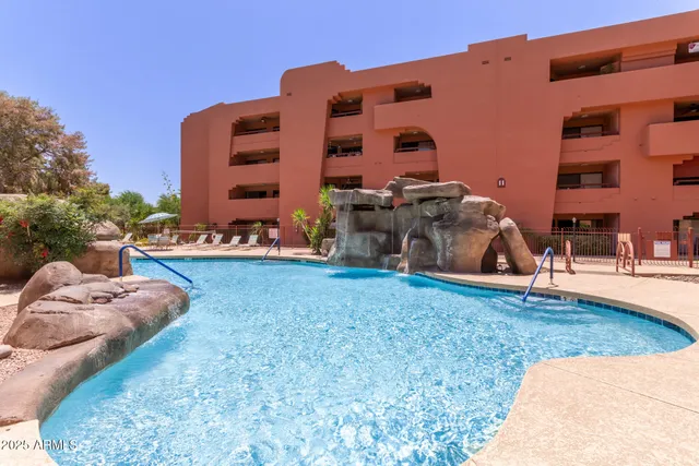 a backyard of a house with table and chairs