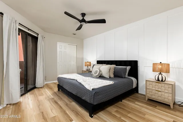 a bedroom with a bed and wooden floor