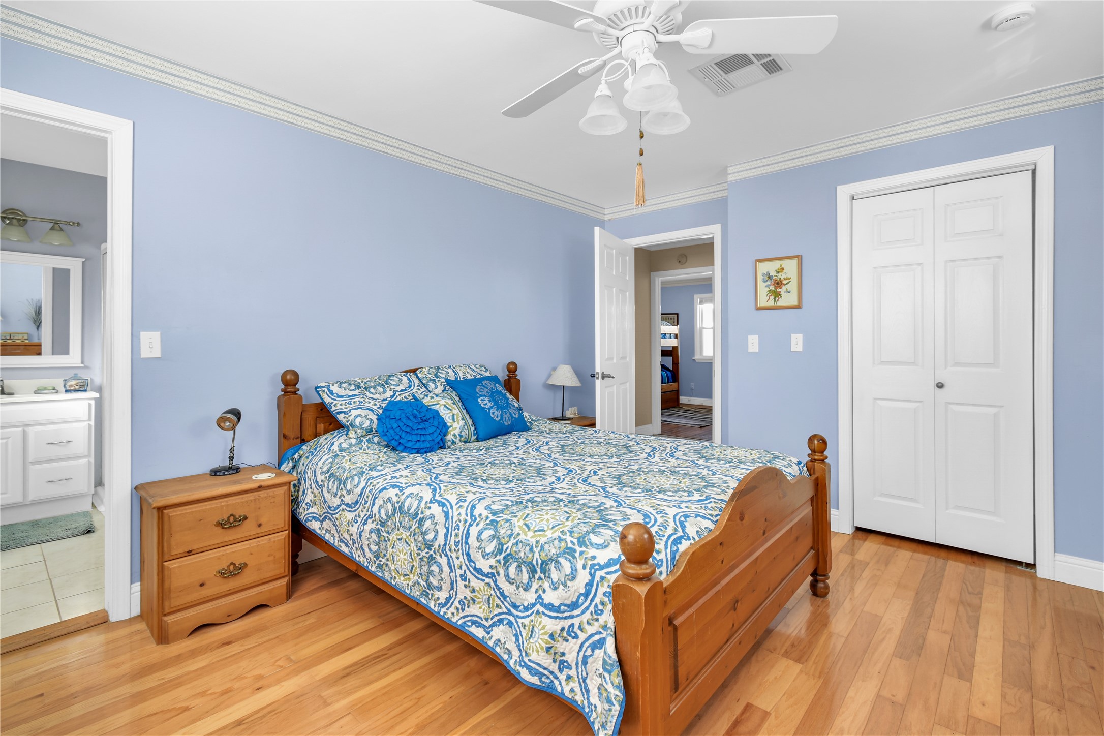 114 Four Master Road Freeport, TX 77541 - Photo 27 of 37 a bedroom with a bed and wooden floor