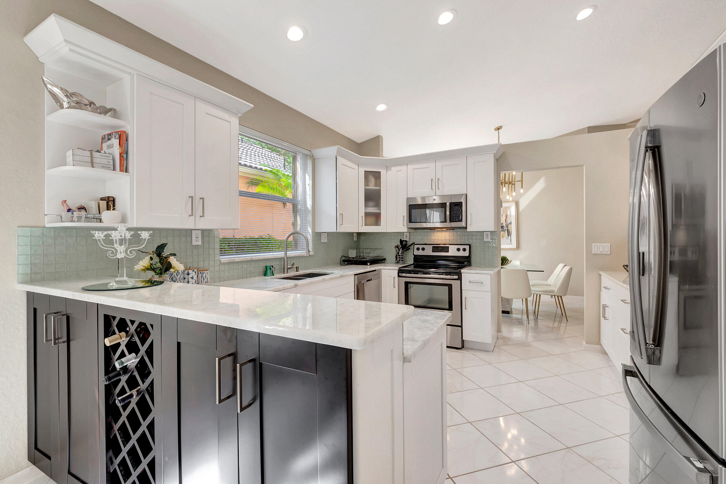 a kitchen with a sink stainless steel appliances cabinets and a counter top space