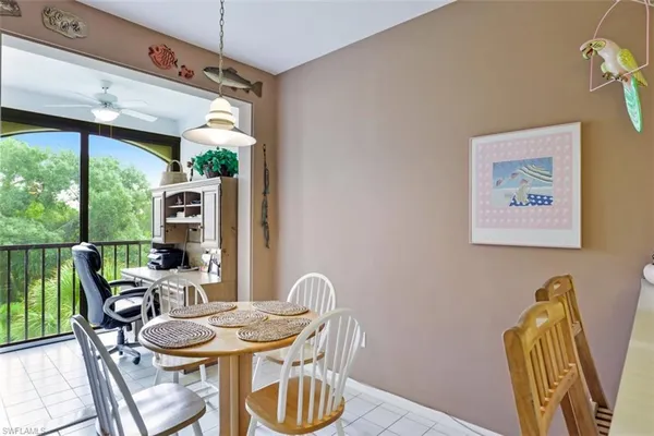 a dining room with furniture window and outside view