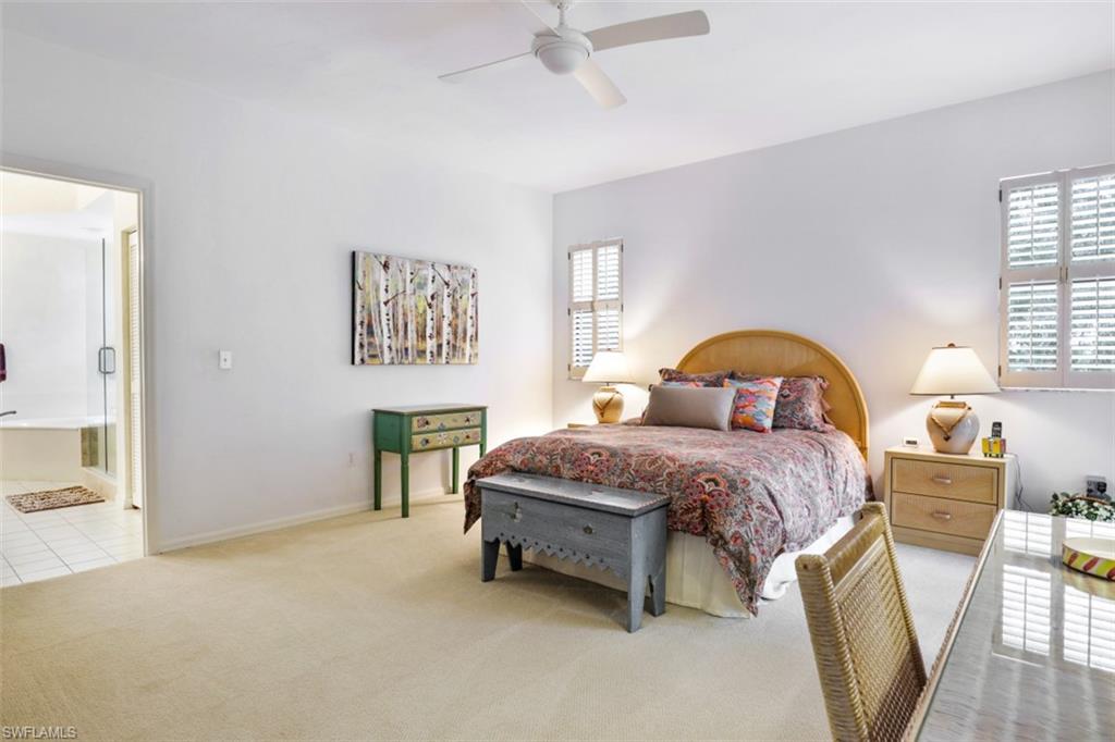 6500 Valen Way, Unit A305 Naples, FL 34108 - Photo 17 of 22 a bedroom with a bed and a dresser