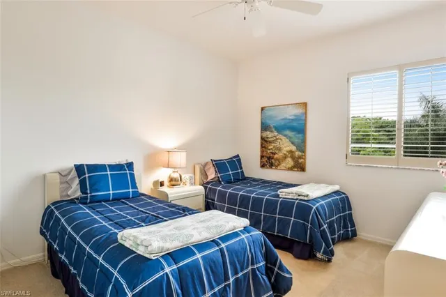 a bedroom with two beds and a window