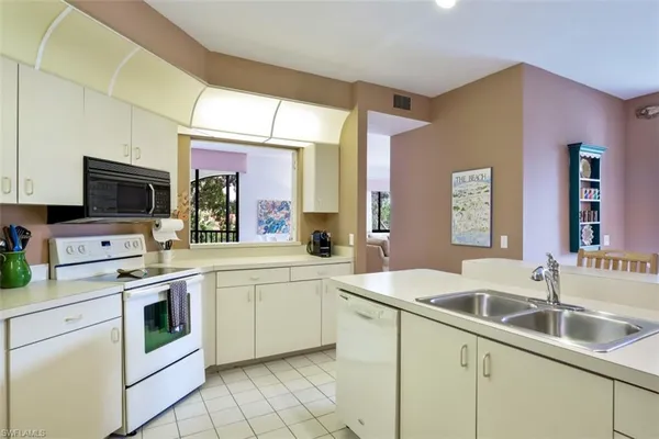 a kitchen with a sink stove and microwave