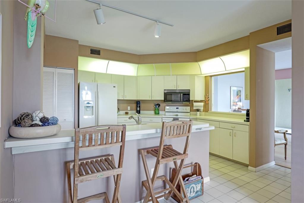 6500 Valen Way, Unit A305 Naples, FL 34108 - Photo 10 of 22 a dining room with furniture and window