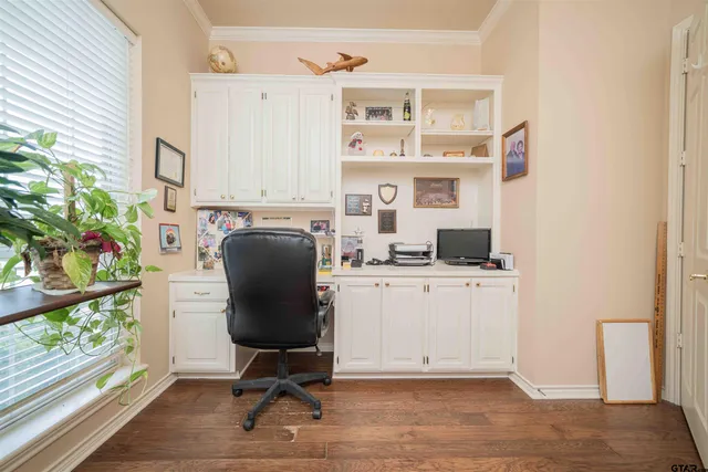 a view of a workspace with furniture and a window