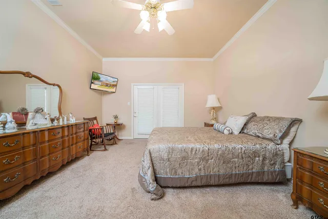 a bedroom with a bed and a dresser in it