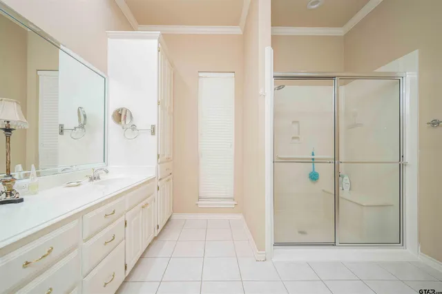 a spacious bathroom with a double vanity sink a mirror and a shower