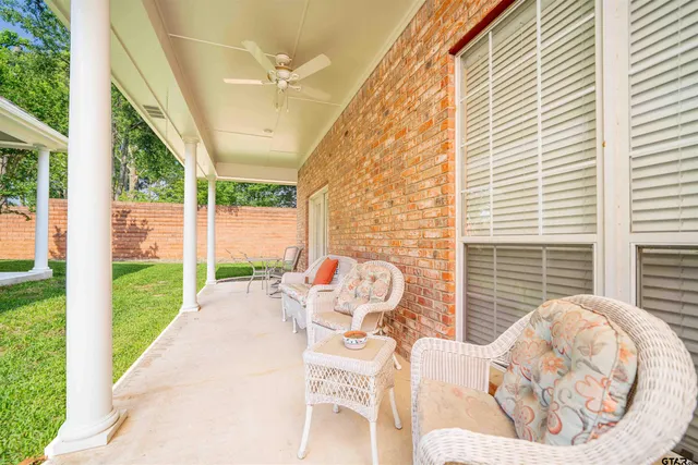 a view of a porch with a table and chairs
