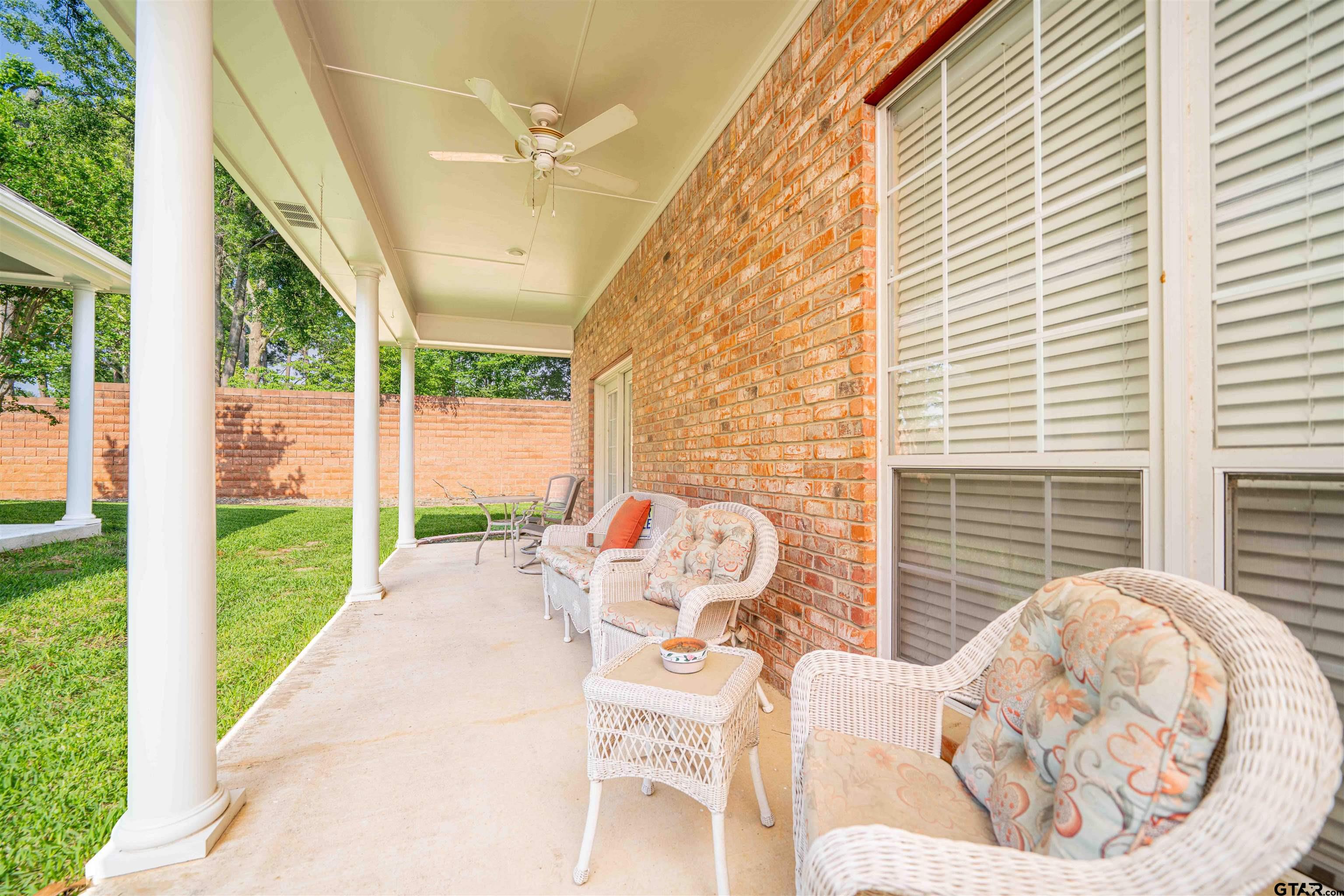 2215 Homestead Lane Tyler, TX 75701 - Photo 22 of 31 a view of a porch with a table and chairs