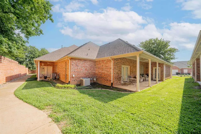 a view of a house with a yard and sitting area