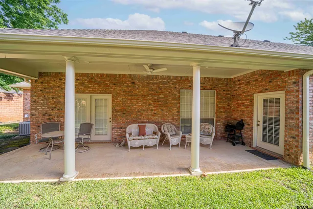a view of a patio with chairs and a yard