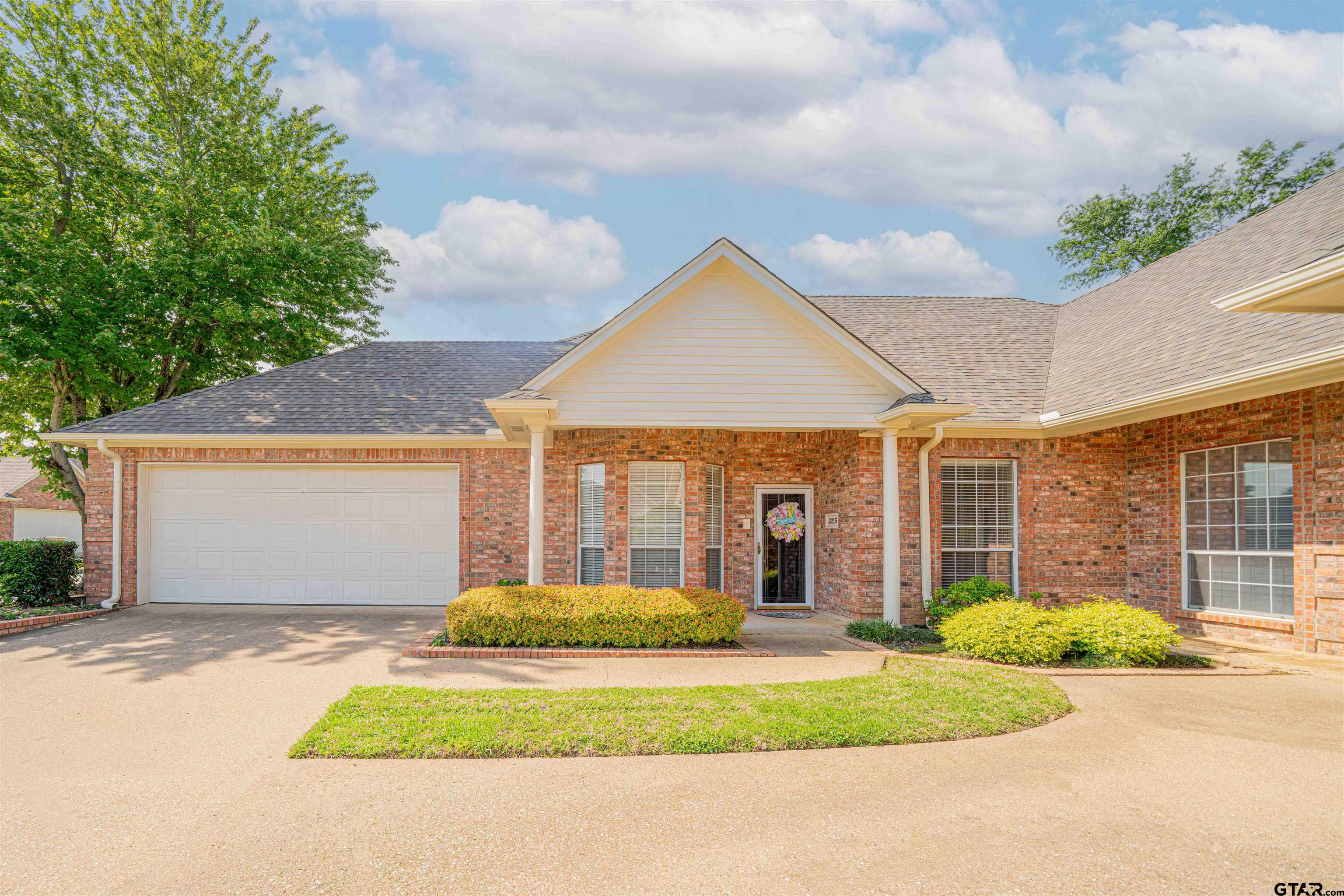 2215 Homestead Lane Tyler, TX 75701 - Photo 29 of 31 a front view of a house with a garden and garage
