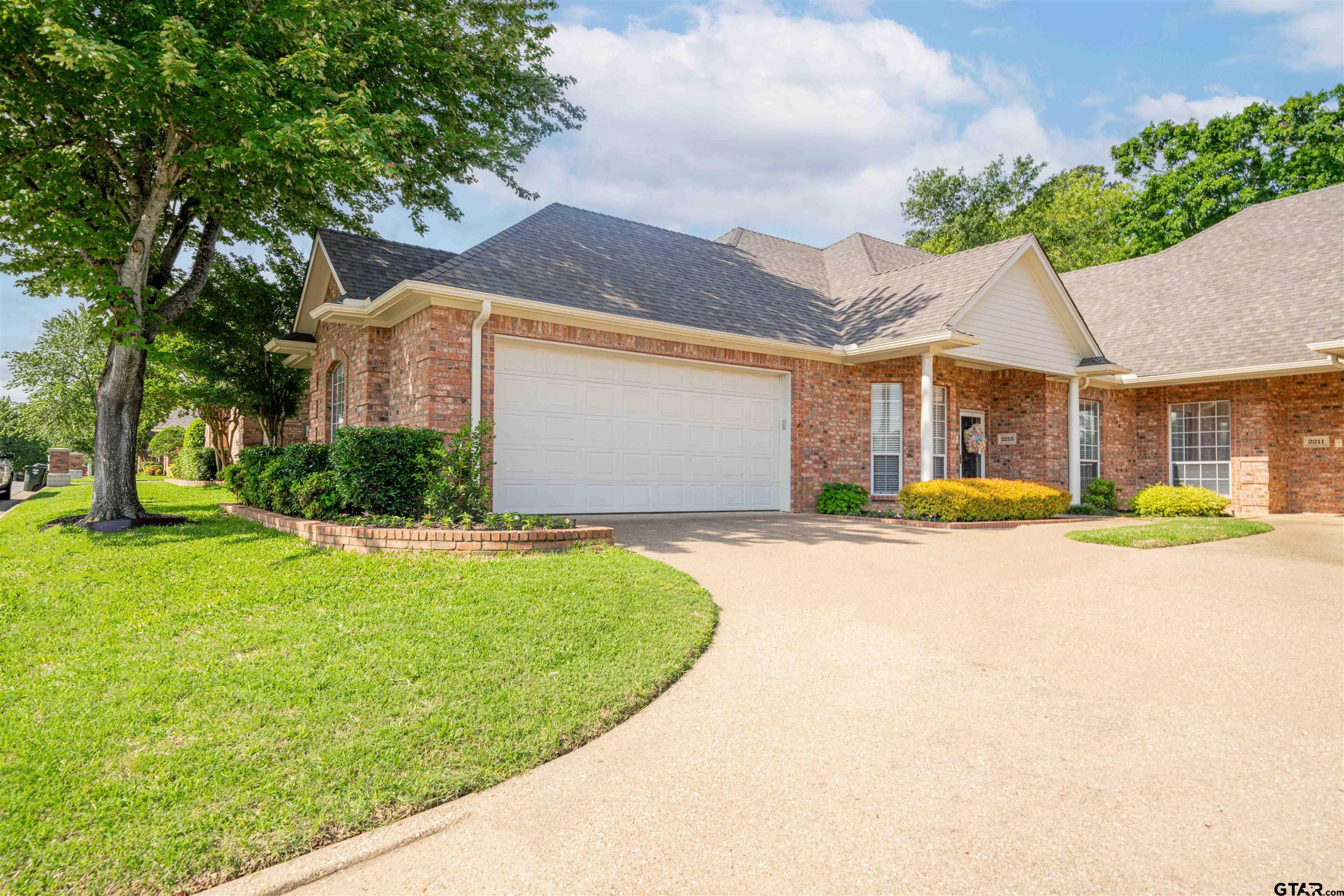 2215 Homestead Lane Tyler, TX 75701 - Photo 30 of 31 a front view of a house with a yard and garage
