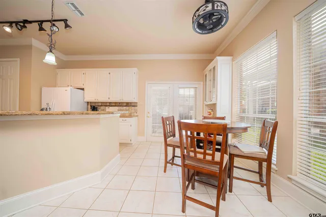 a view of a dining room with furniture and a window