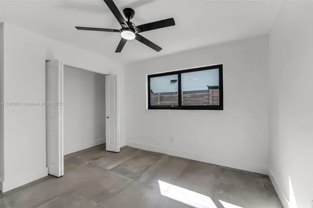 a view of a hallway with a ceiling fan