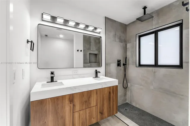 a bathroom with a sink vanity and mirror
