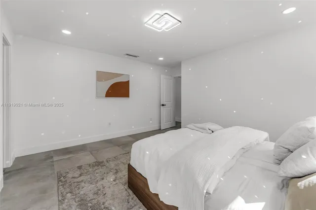 a bedroom with a bed and a painting