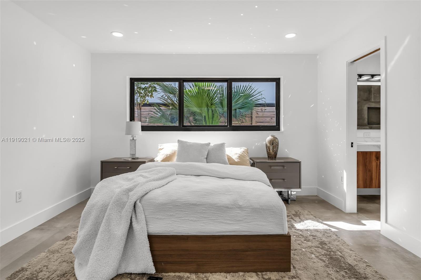 7120 Southwest 92nd Avenue Miami, FL 33173 - Photo 23 of 37 a bed sitting in a bedroom next to a window