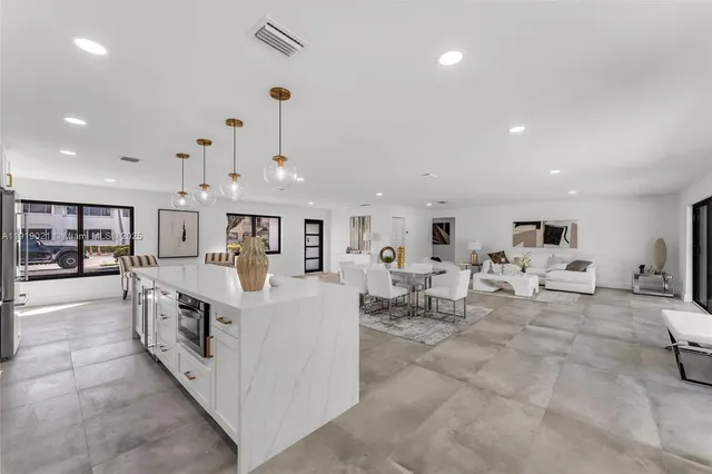 a large white kitchen with lots of counter space