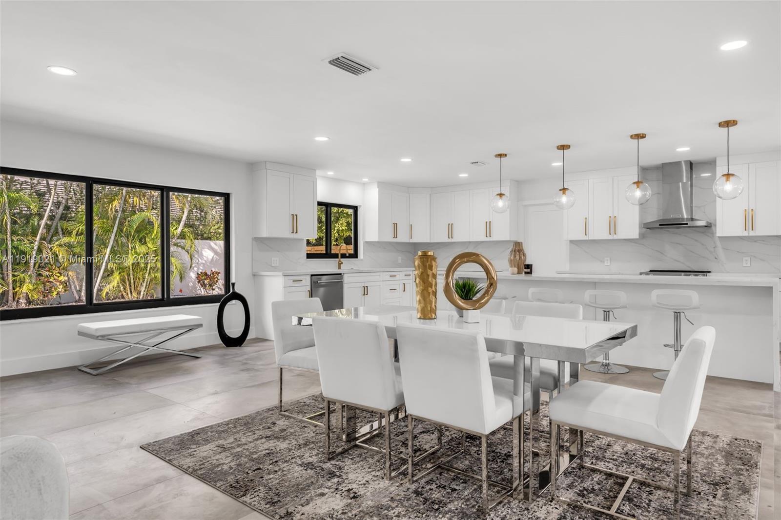 7120 Southwest 92nd Avenue Miami, FL 33173 - Photo 29 of 37 a kitchen with a dining table chairs and refrigerator