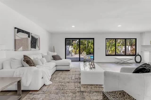 a living room with furniture and a large window