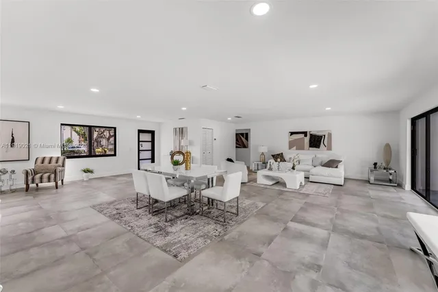 a living room with lots of furniture and white walls
