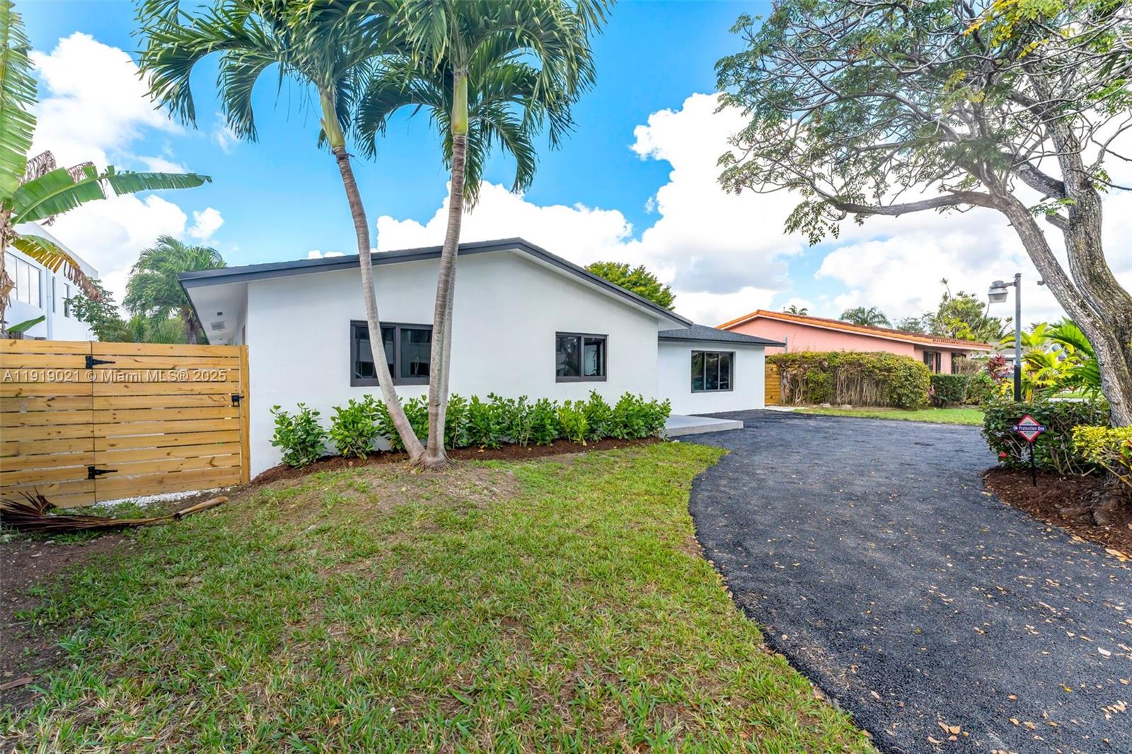 7120 Southwest 92nd Avenue Miami, FL 33173 - Photo 4 of 37 a front view of a house with garden