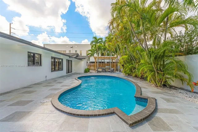 a view of a swimming pool with a patio