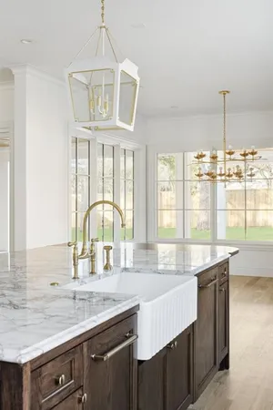 an open kitchen with granite countertop a sink and dishwasher with wooden floor