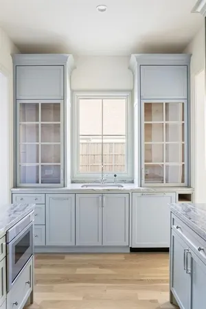 a view of a kitchen with granite countertop a sink and a stove top oven
