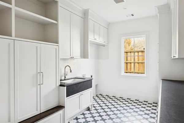 a kitchen with granite countertop a sink a stove and refrigerator