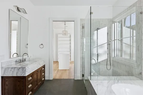a bathroom with a granite countertop sink shower and a mirror