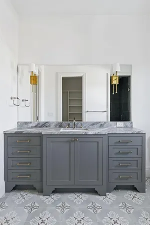 a bathroom with a granite countertop sink and a mirror