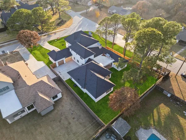 an aerial view of a house with a garden and trees